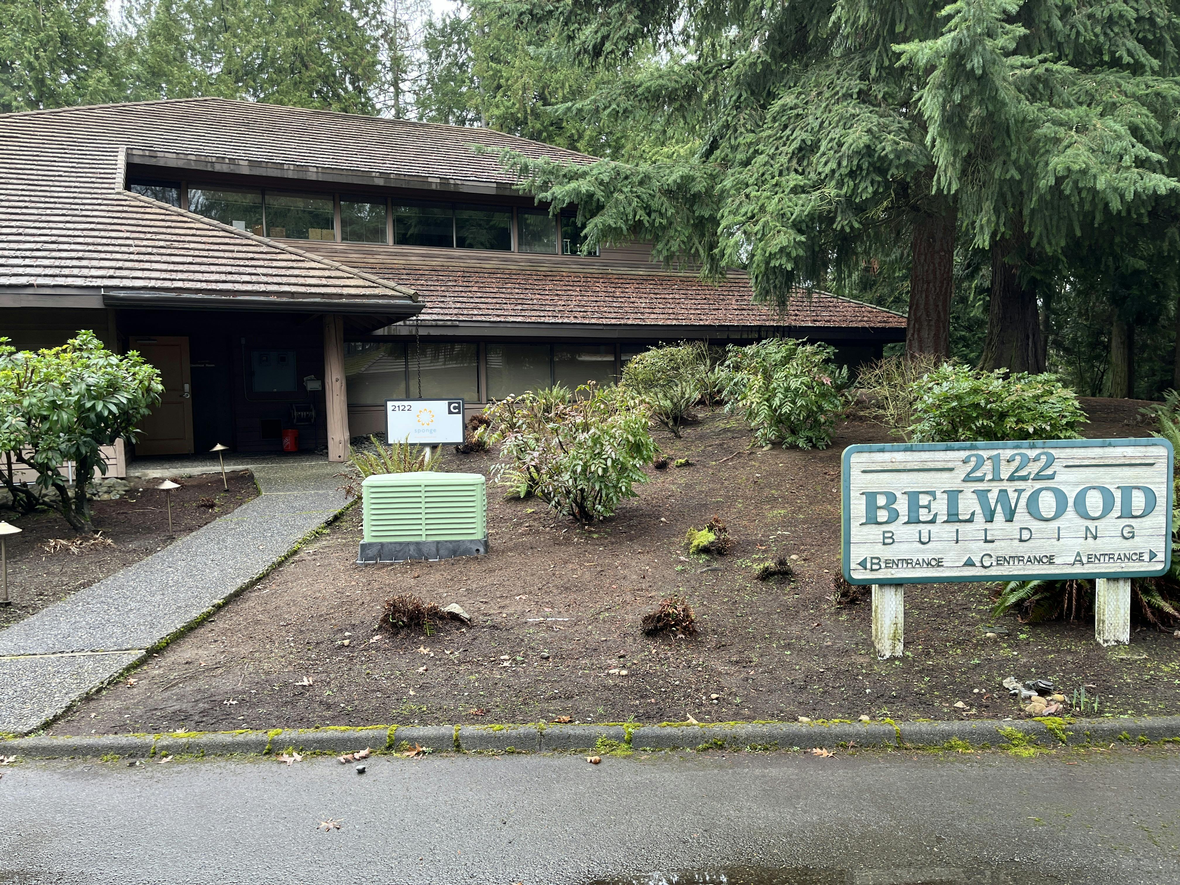 Building with a brown roof and a sign that reads "2122 Belwood Building"
