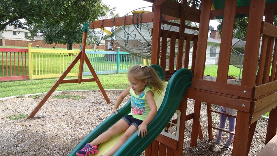 Child going down a slide on a playground