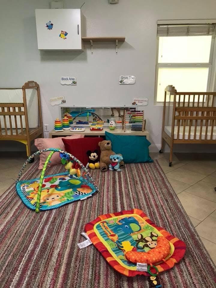 Infant play mats and cribs in a room