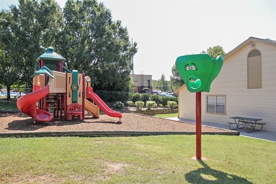 Playground with slides and a green climbing structure