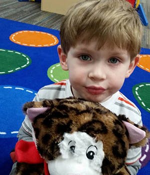 Child holding a stuffed animal