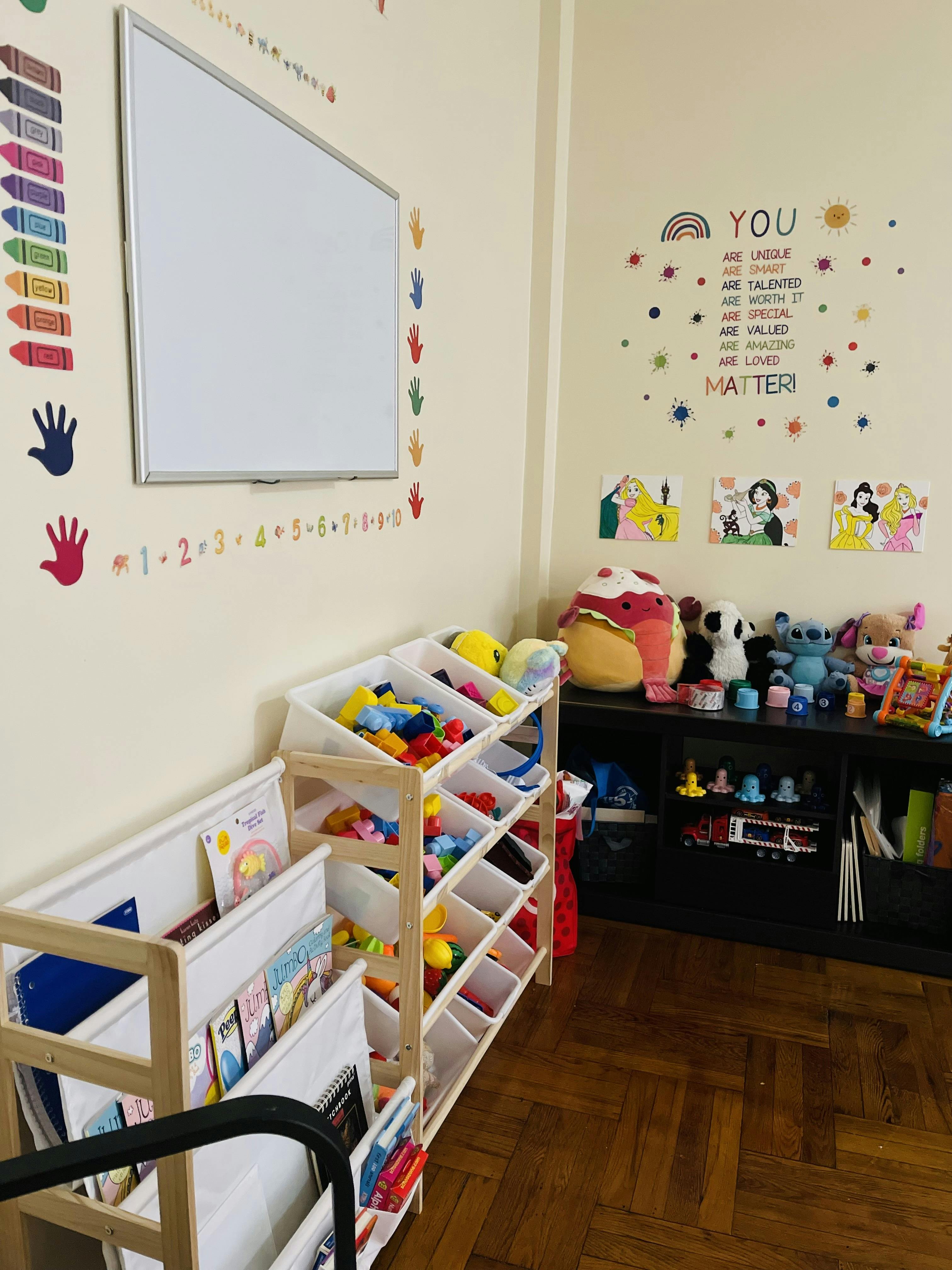 Classroom with whiteboard, toy storage, and wall decorations