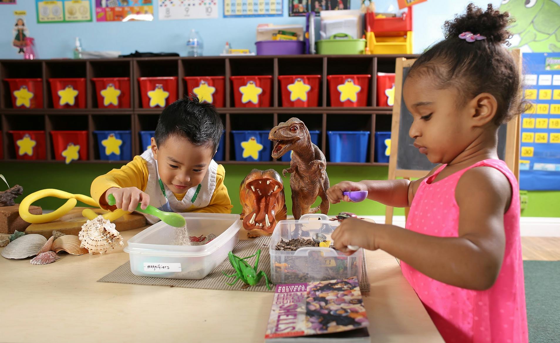 Two children playing with toys at a table