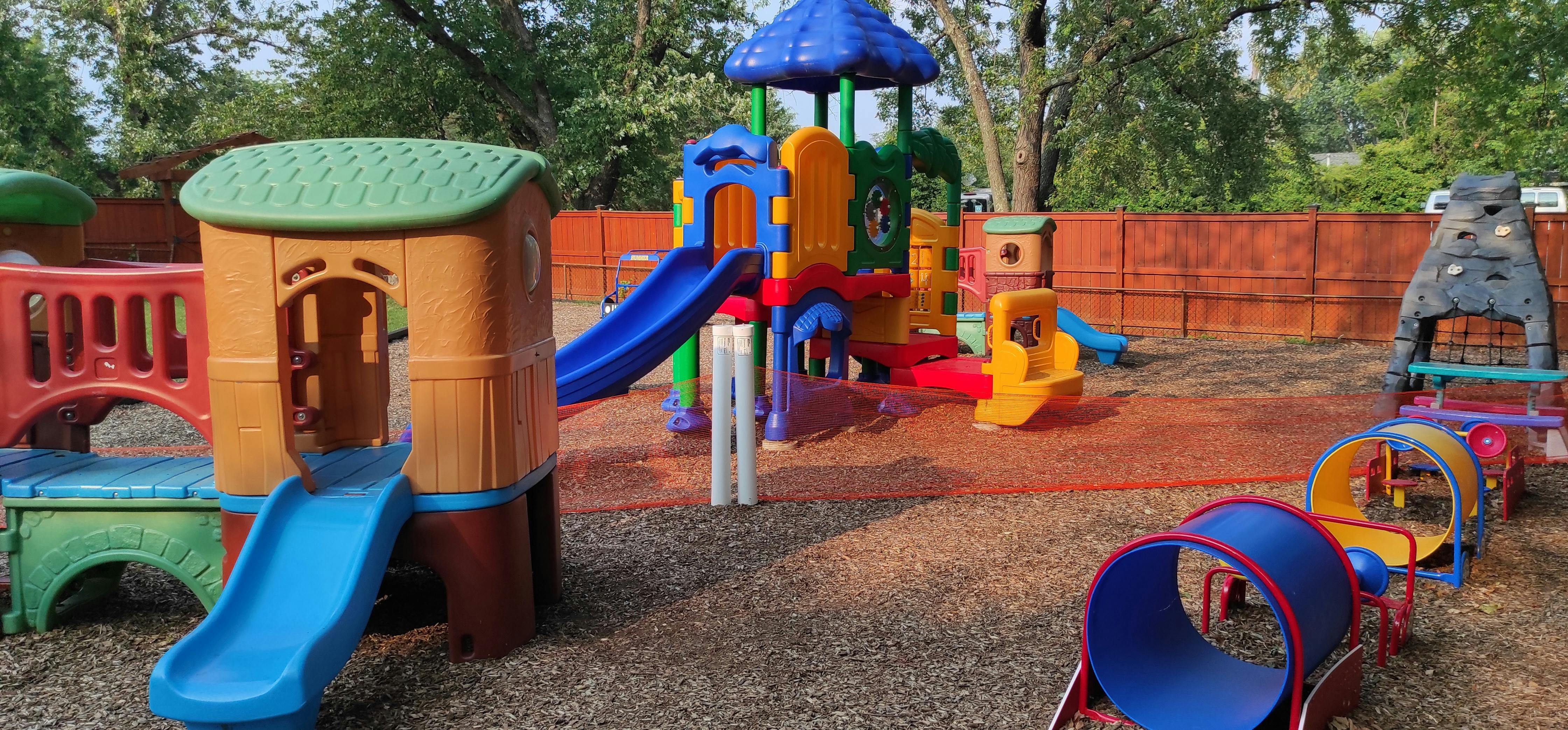Colorful playground with slides, tunnels, and climbing structures