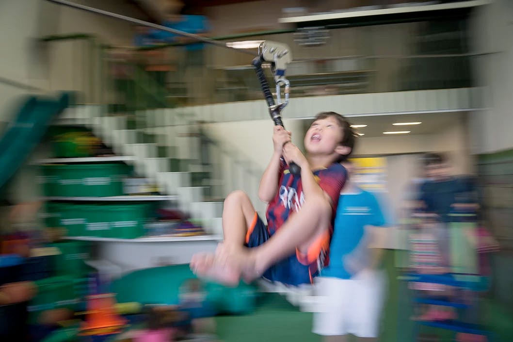 Child on a zip line indoors