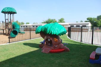 Playground with treehouse-shaped play structure and slide
