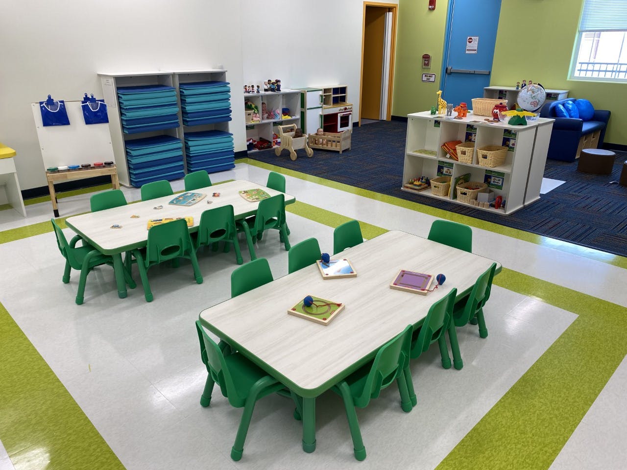 Classroom with small tables and green chairs