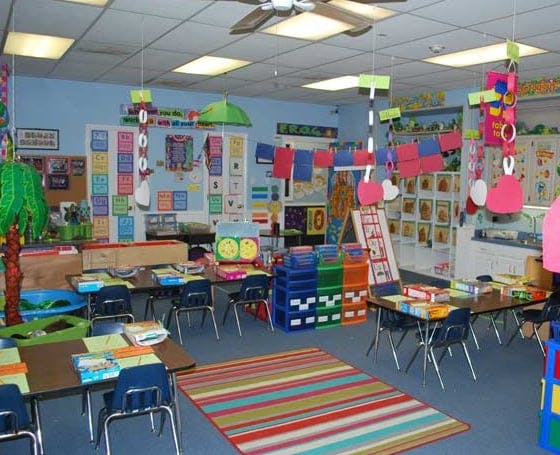 Empty classroom with small tables and chairs, colorful decorations