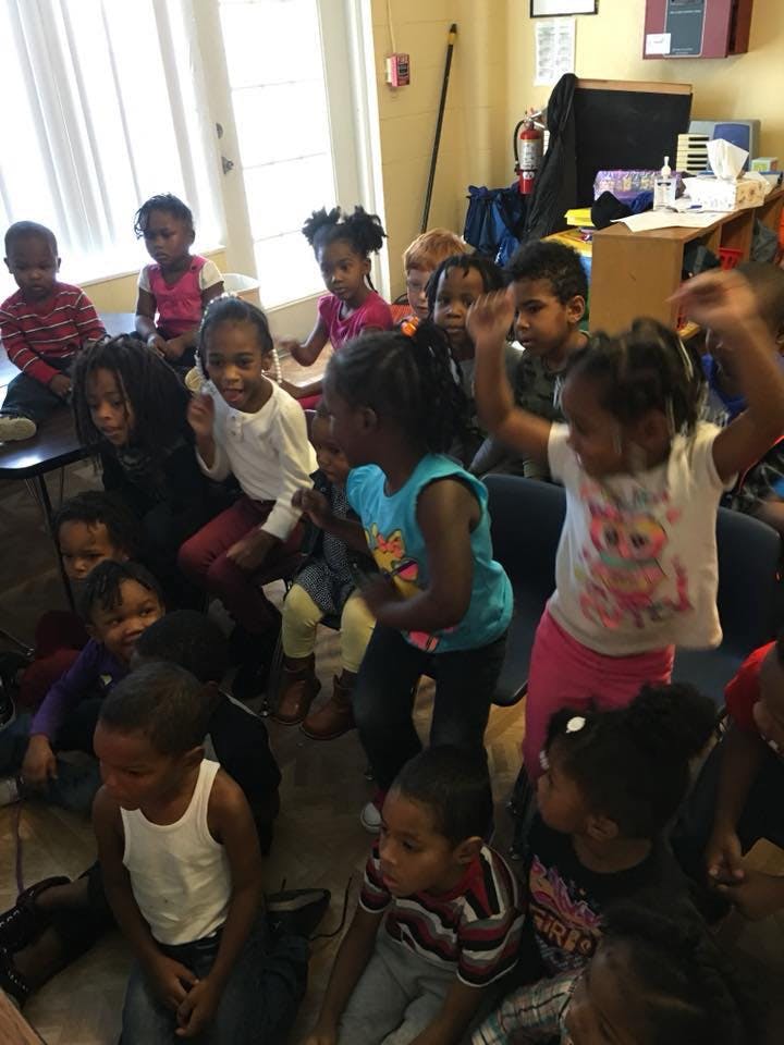 Group of children sitting and standing in a room