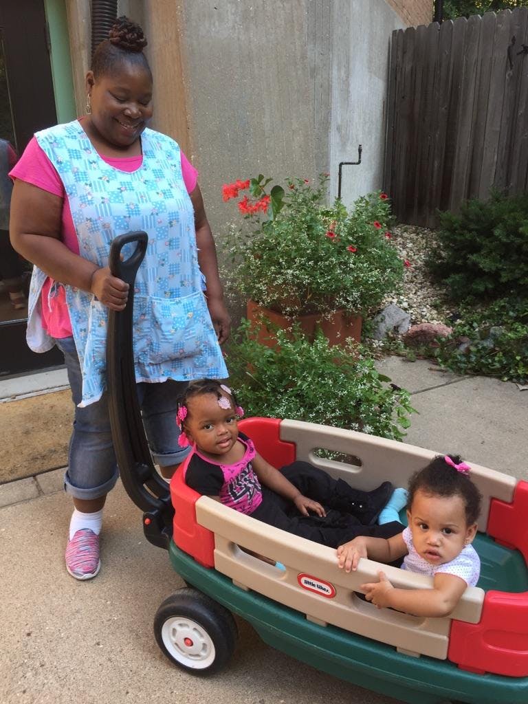 Person pulling two children in a wagon