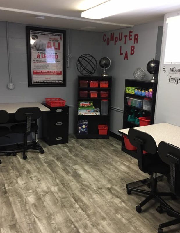 Computer lab with desks, chairs, and storage shelves