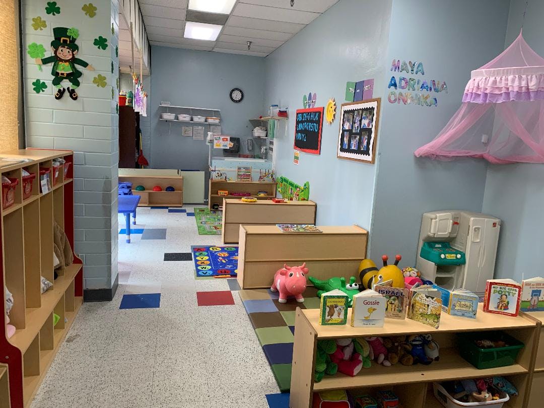 Empty classroom with cubbies, tables, and toys