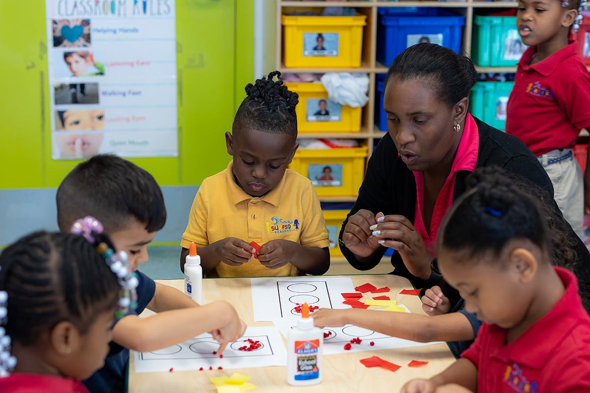 Adult and children doing an art project at a table