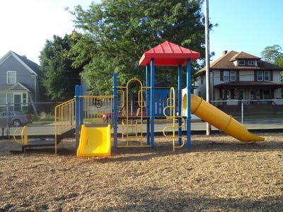 Playground with yellow slides and blue and red climbing structure