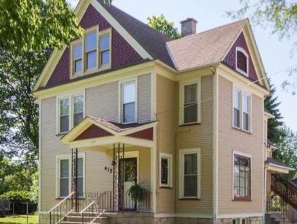 Large house with multiple gables and a covered porch