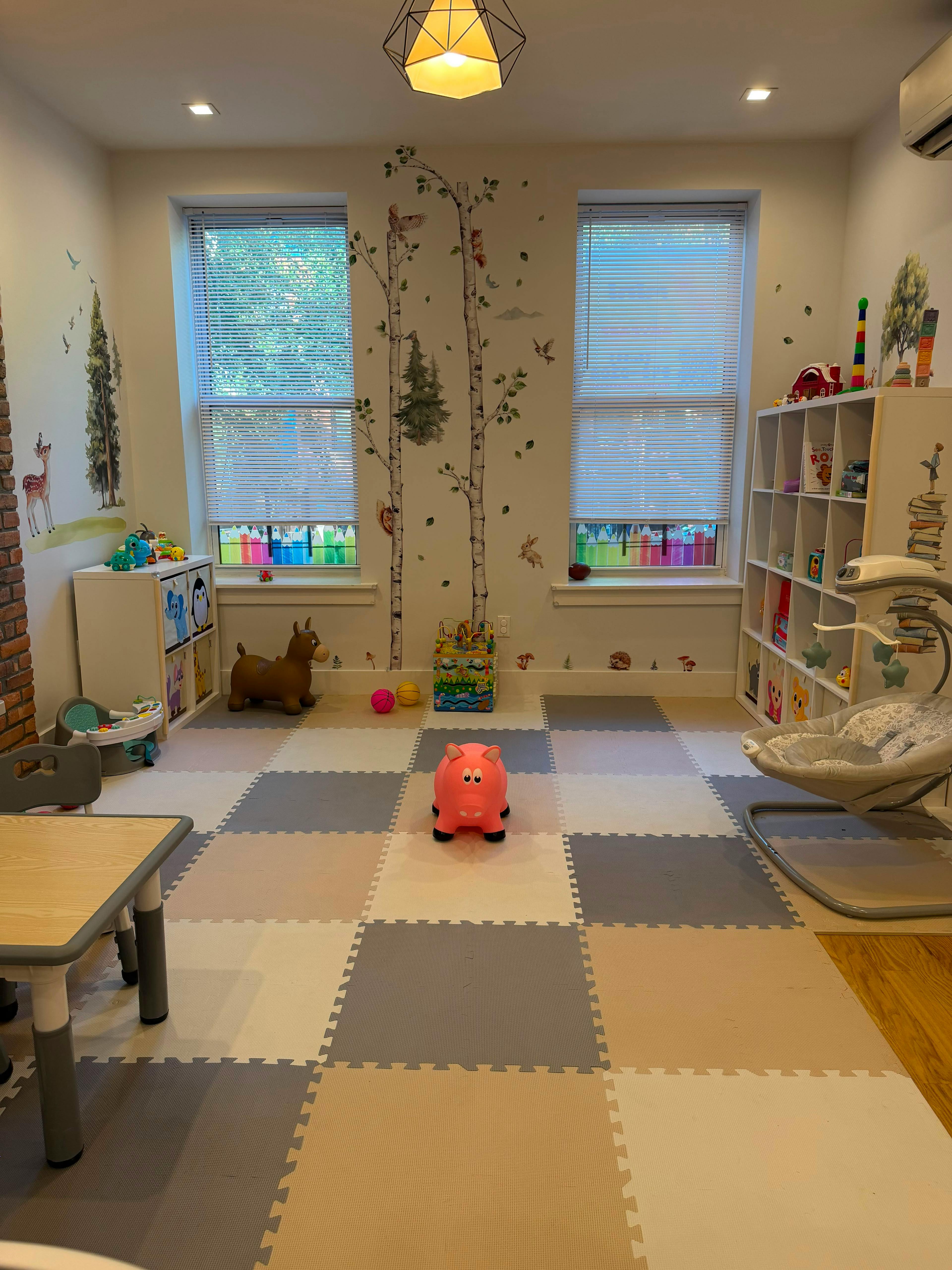 Playroom with children toys, furniture, and wall decals