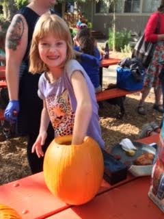 Child carving a pumpkin