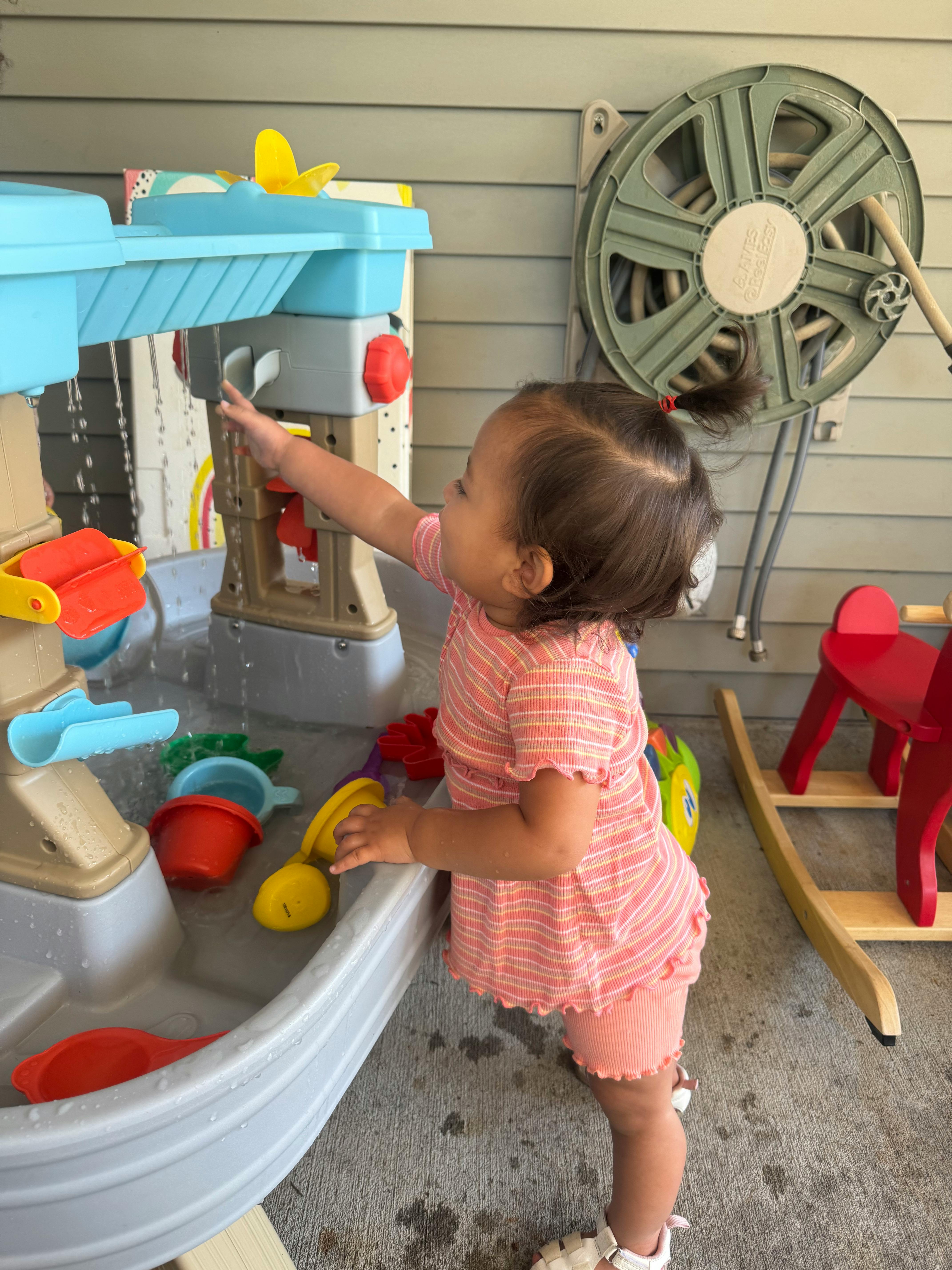 Child playing with a water table toy