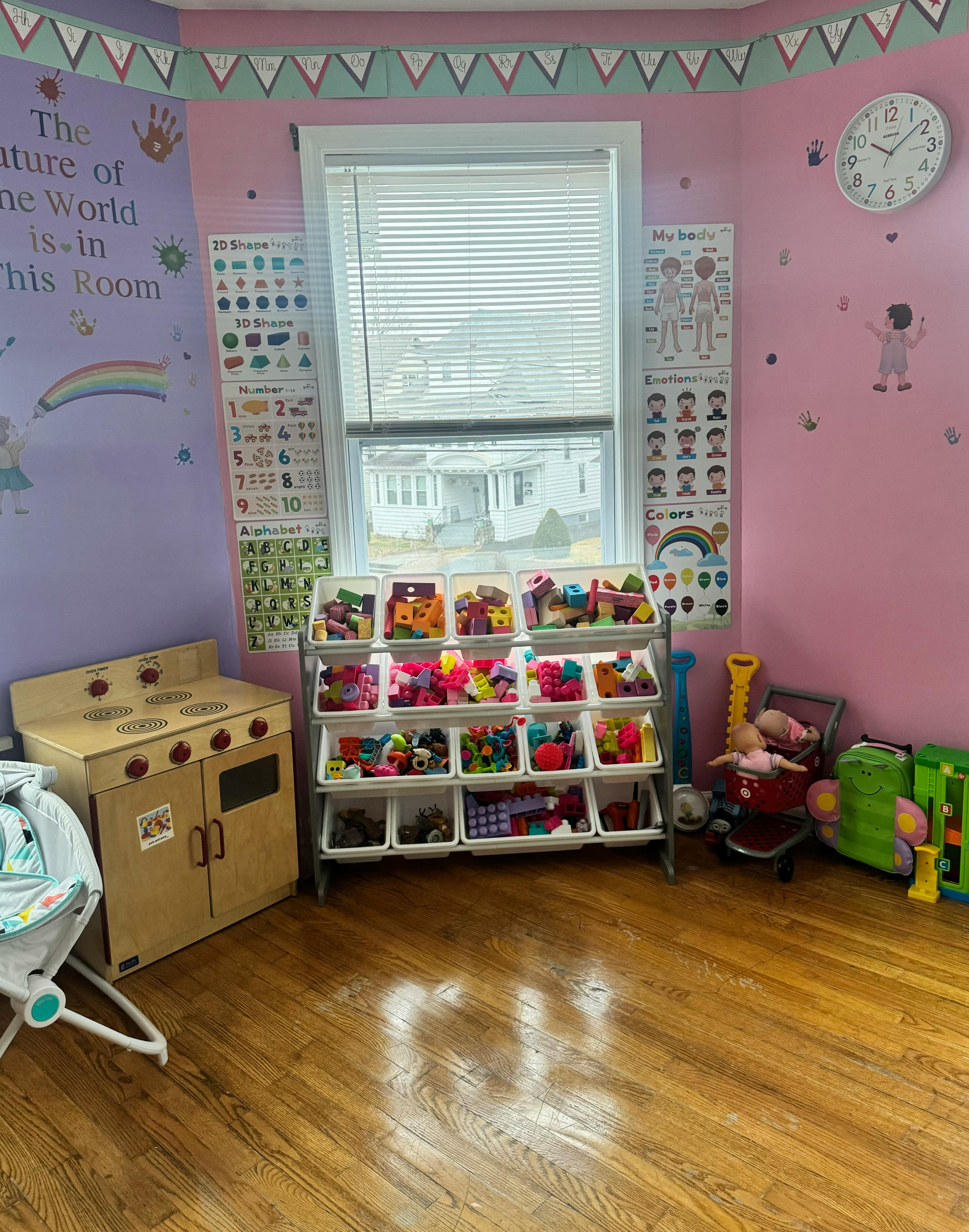 Playroom with toy storage, play kitchen, and baby bouncer