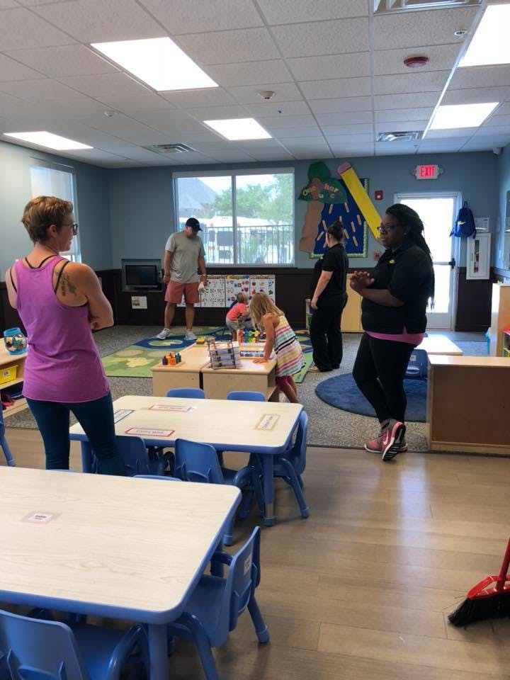 Adults and children in a classroom