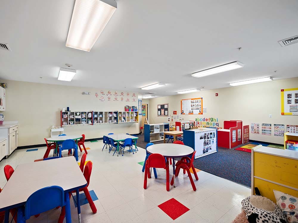 Empty classroom with small tables and chairs