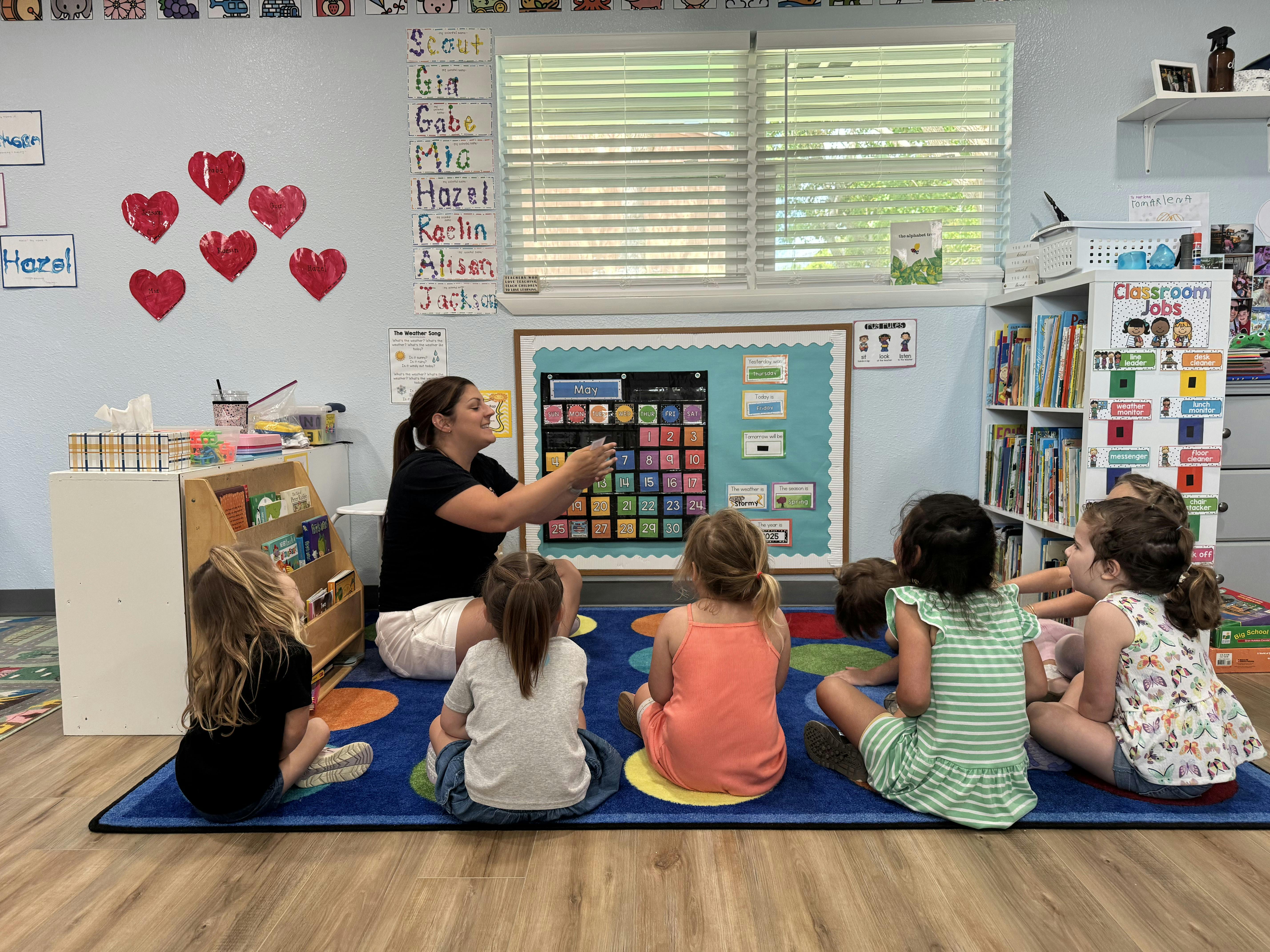 Adult teaching children in a classroom