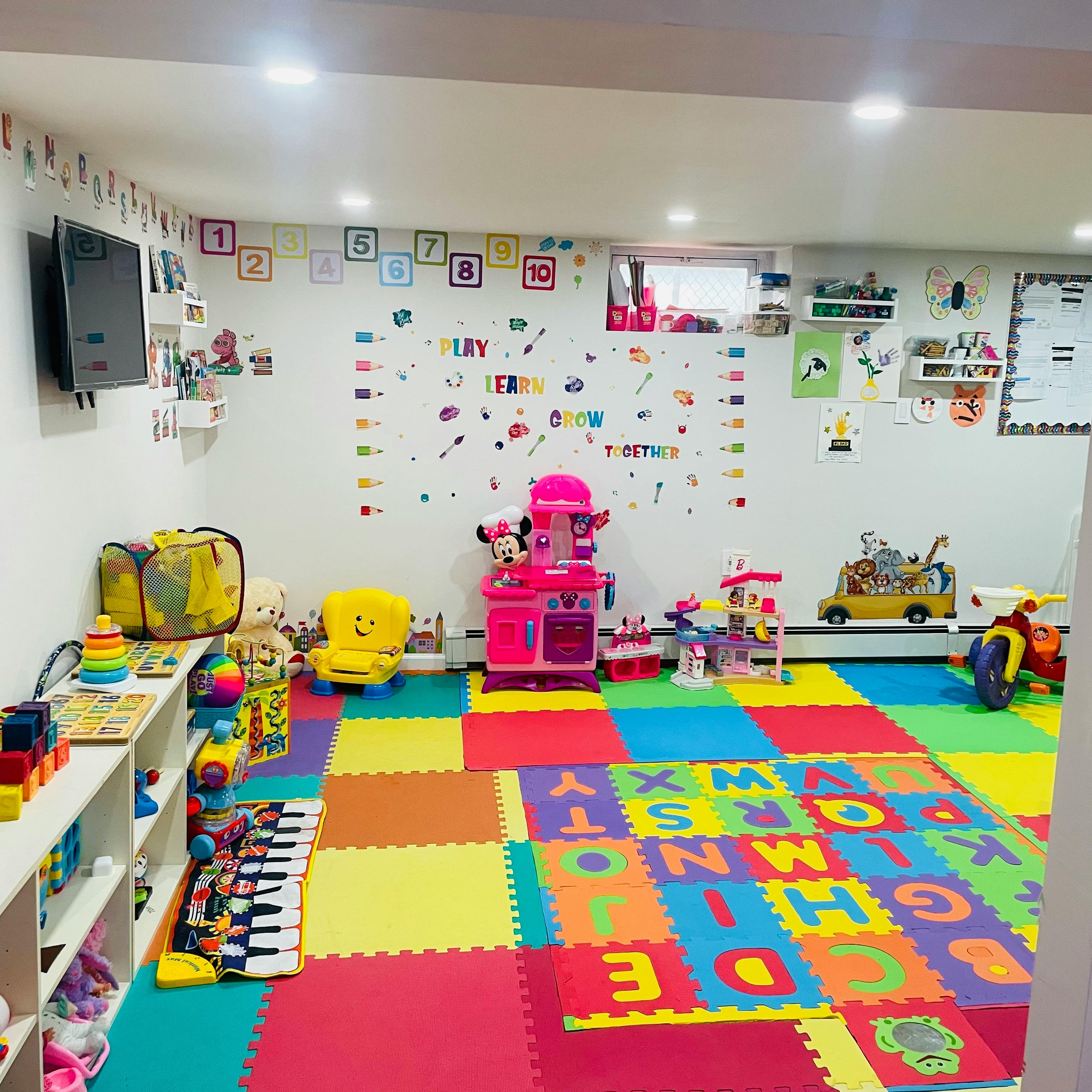 Playroom with colorful alphabet floor mats and various toys
