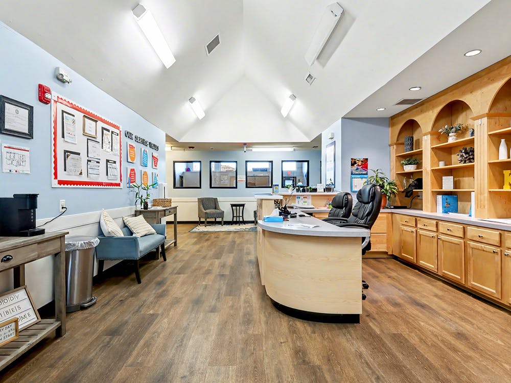 Reception desk with office chairs and light wood cabinets