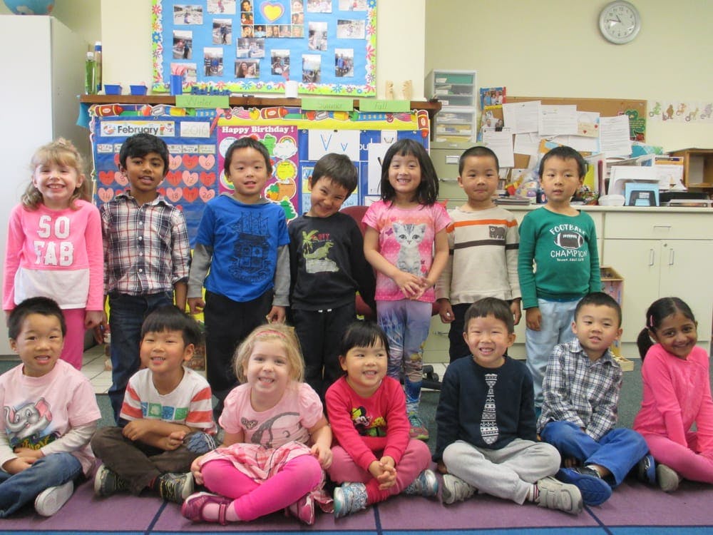 Group of children posing in a classroom