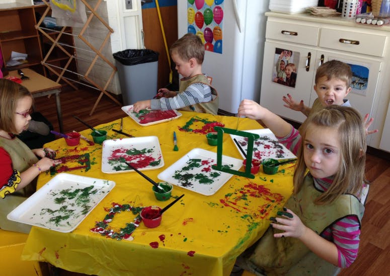 Children painting at a table