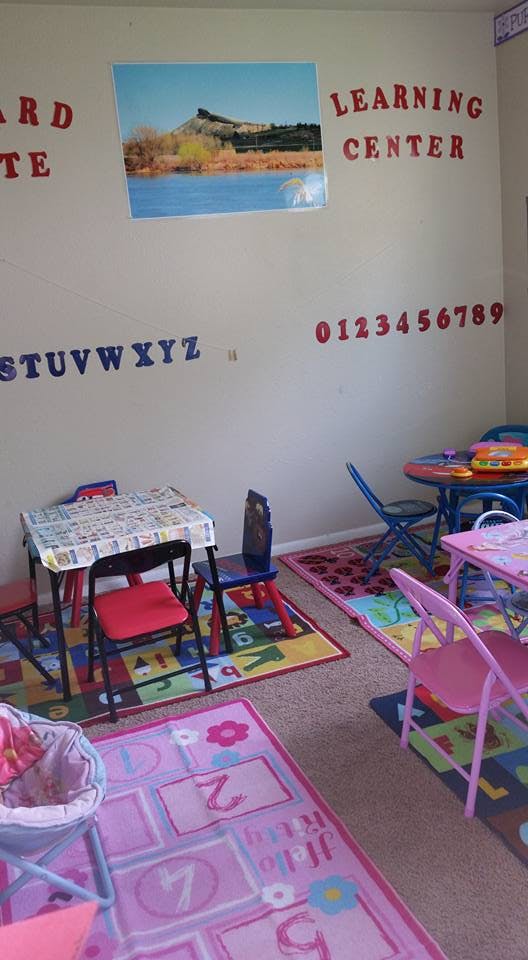Classroom with small tables and chairs, alphabet and numbers on the wall