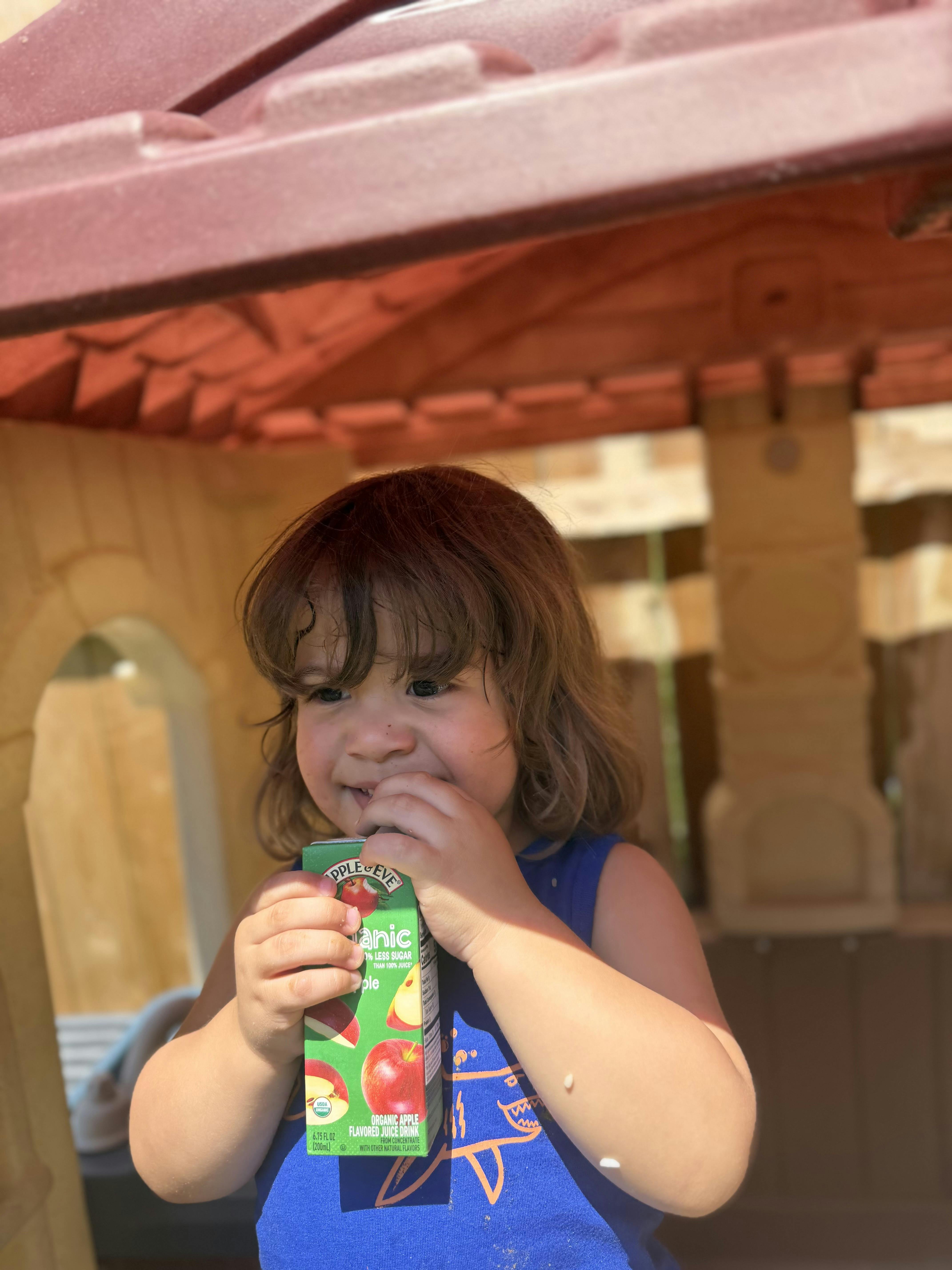 Child drinking Apple & Eve organic apple juice