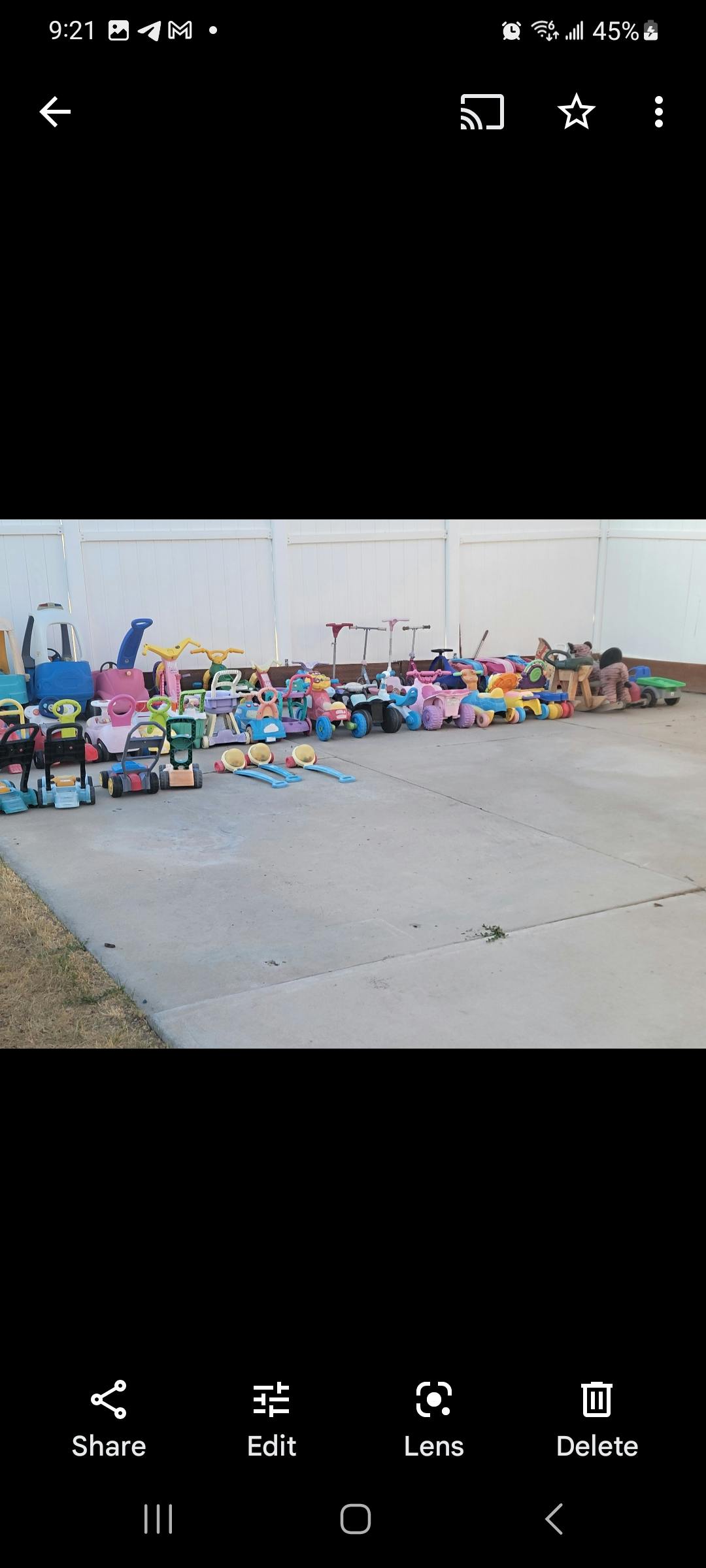 Assortment of children's toys and ride-ons on a paved surface