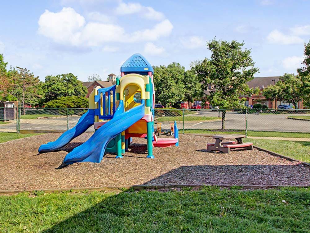 Playground with blue slides and a small picnic table
