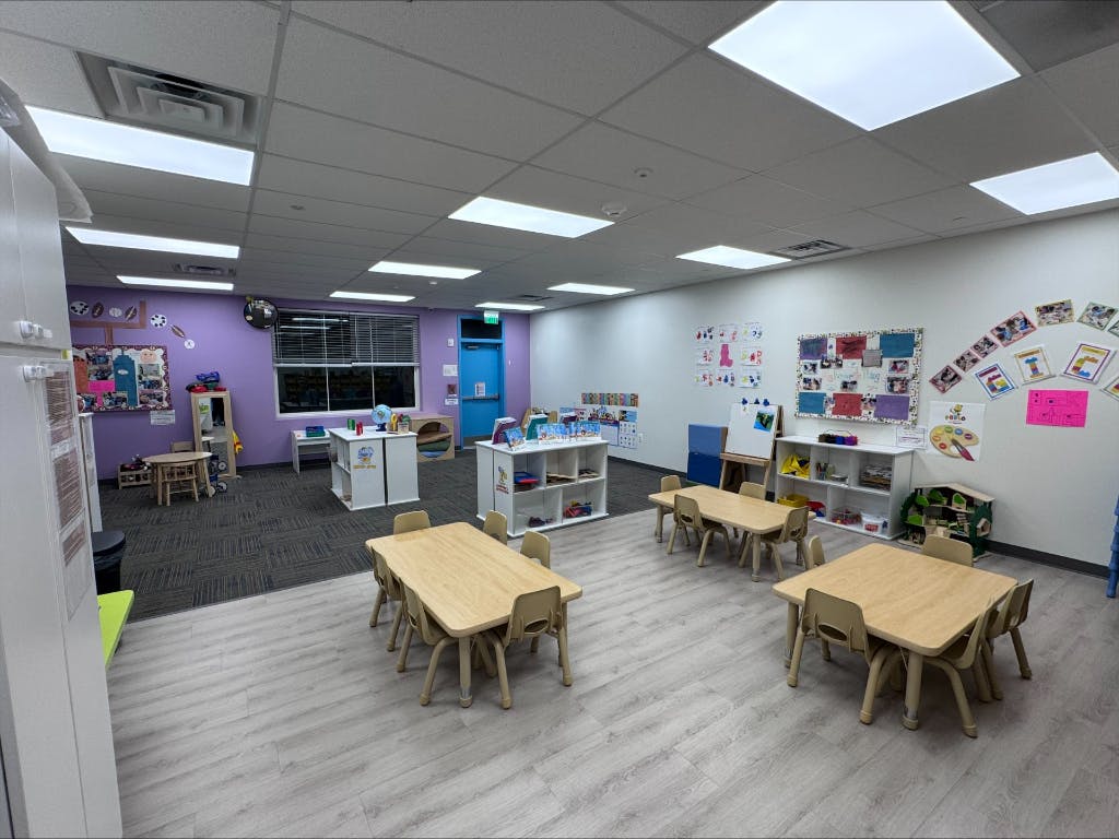 Empty classroom with small tables and chairs