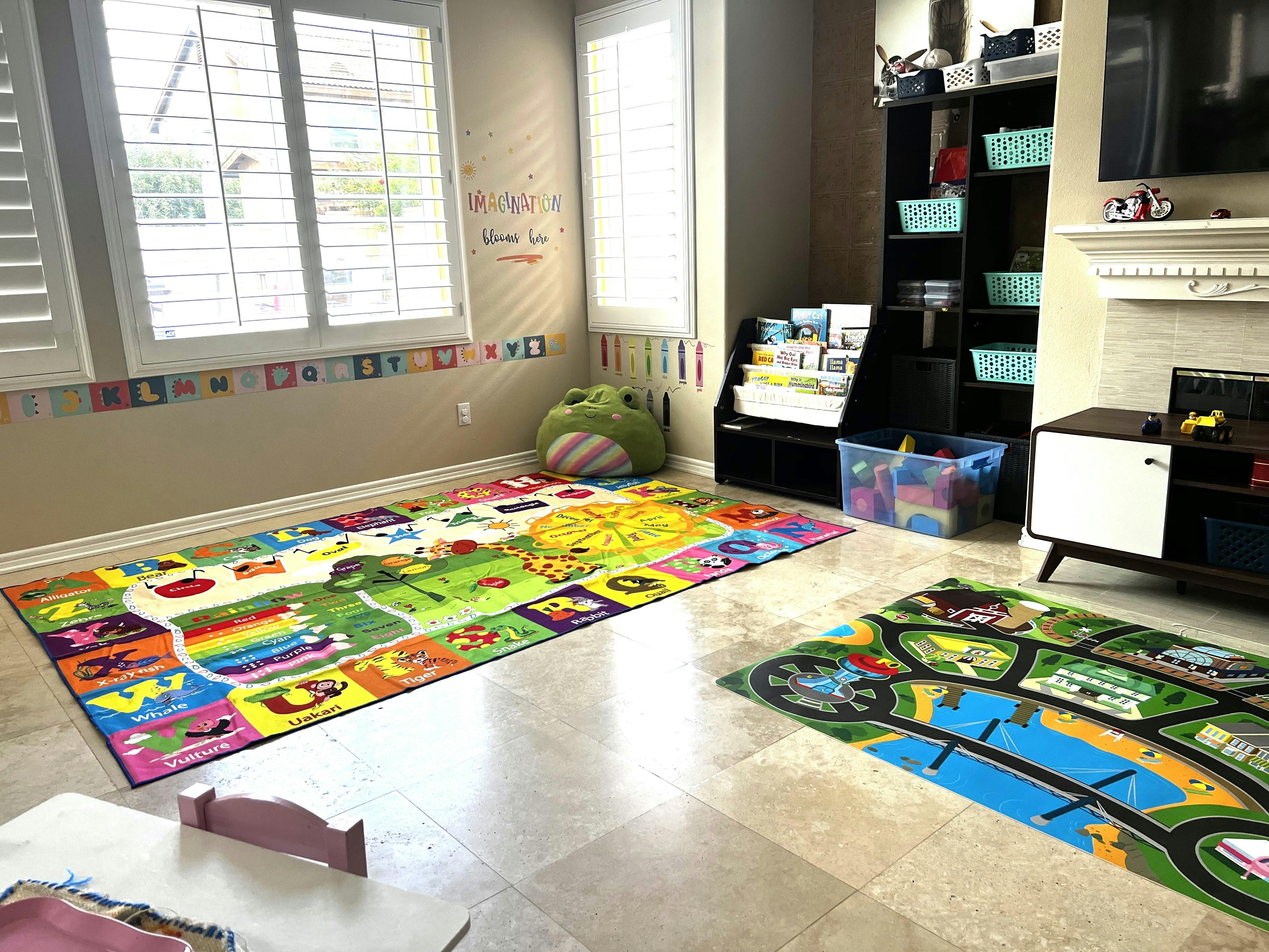 Children's playroom with alphabet and map rugs, storage shelves, and window shutters