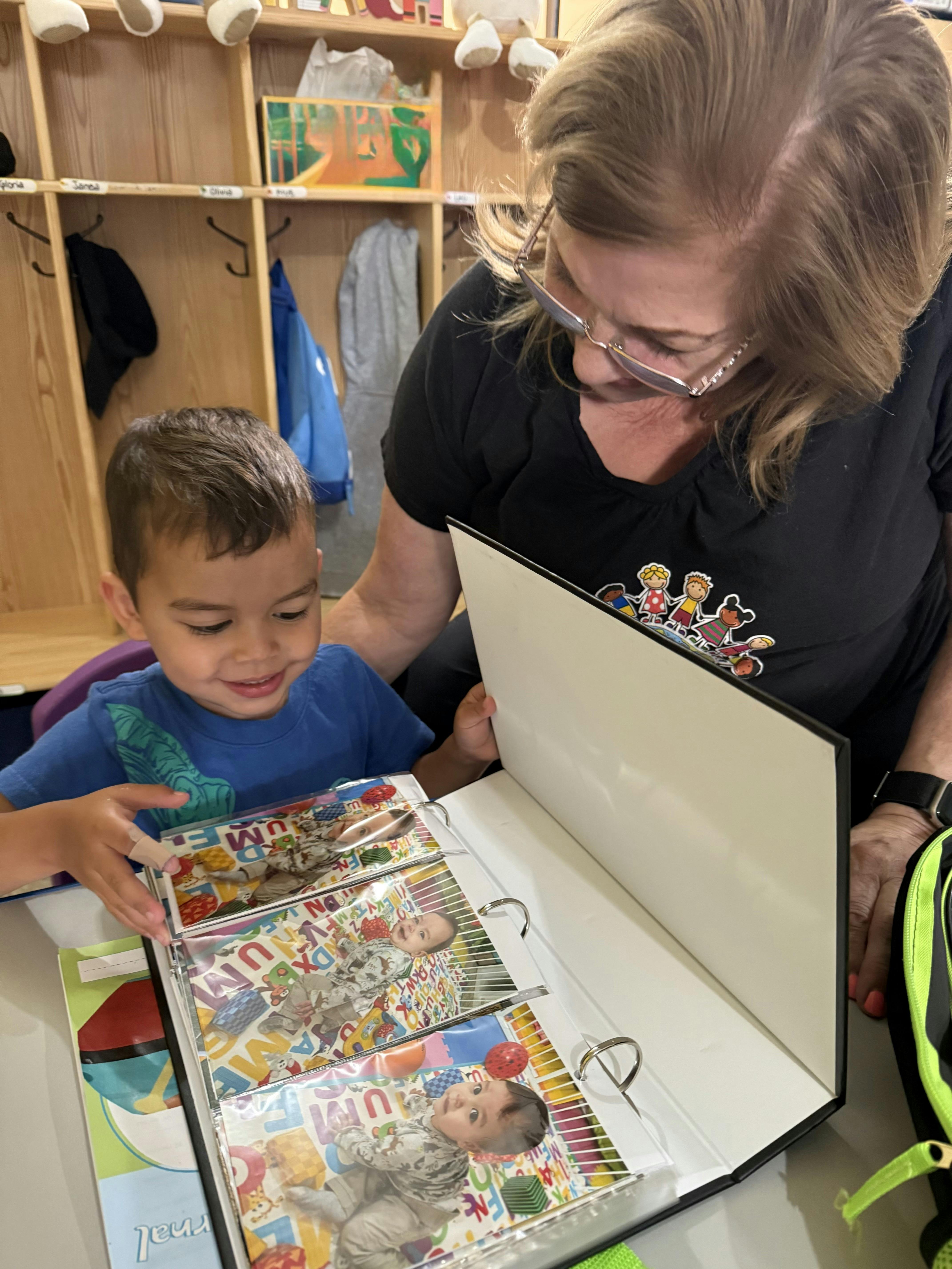 Adult and child looking at a photo album