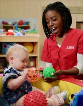 Adult and child playing with textured balls