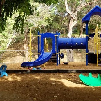 Blue and yellow playground equipment with slides and tunnels