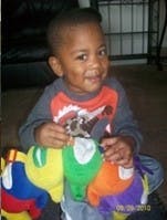 Child holding a colorful stuffed toy