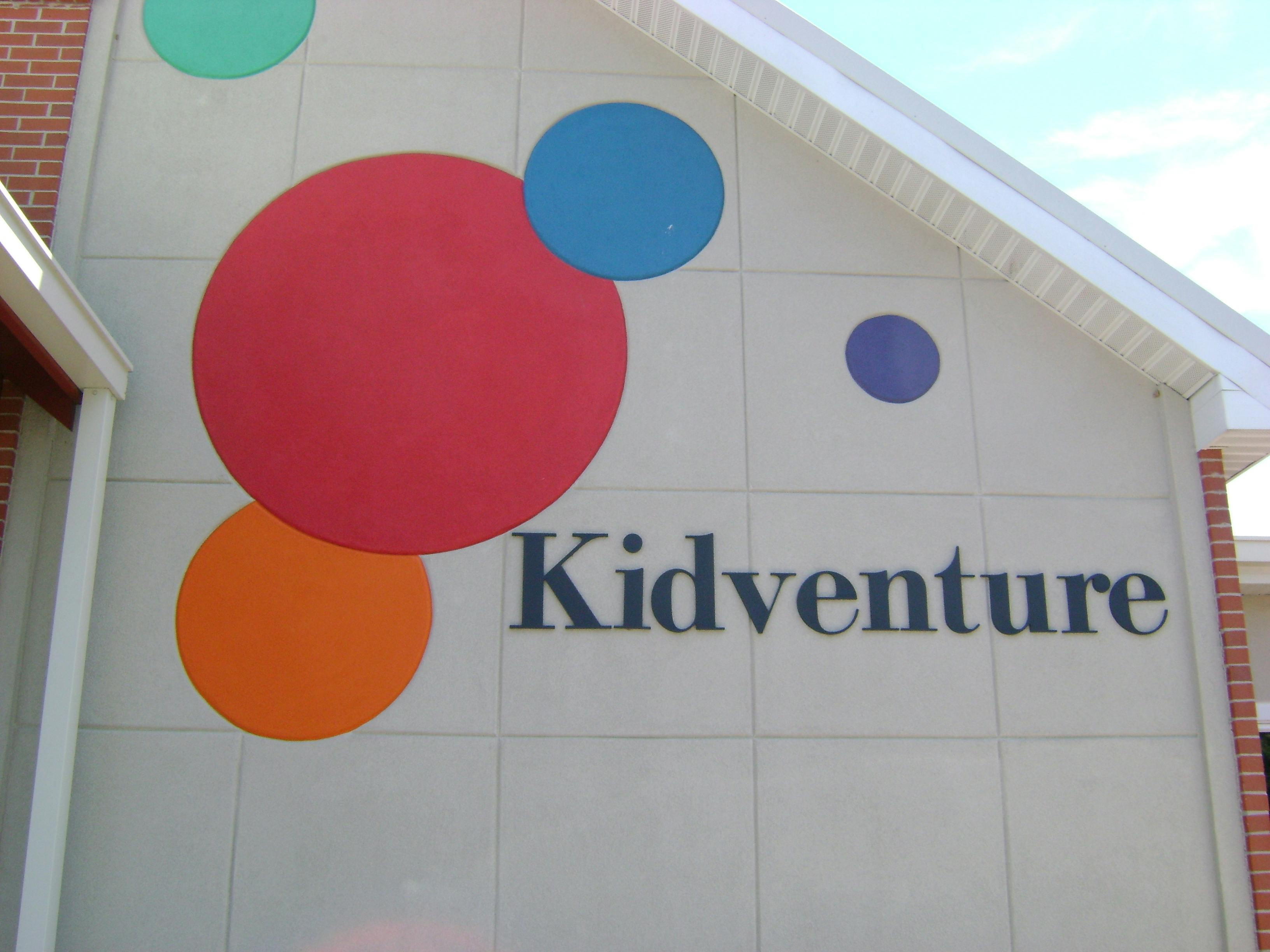 Building exterior with colorful circles and the word Kidventure