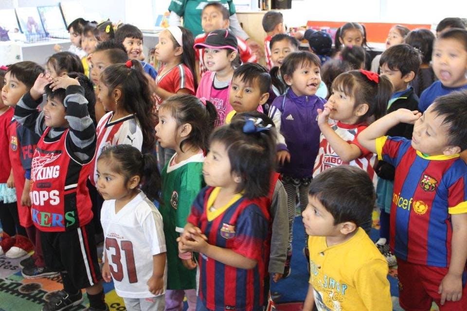 Group of children standing and looking forward in the same direction
