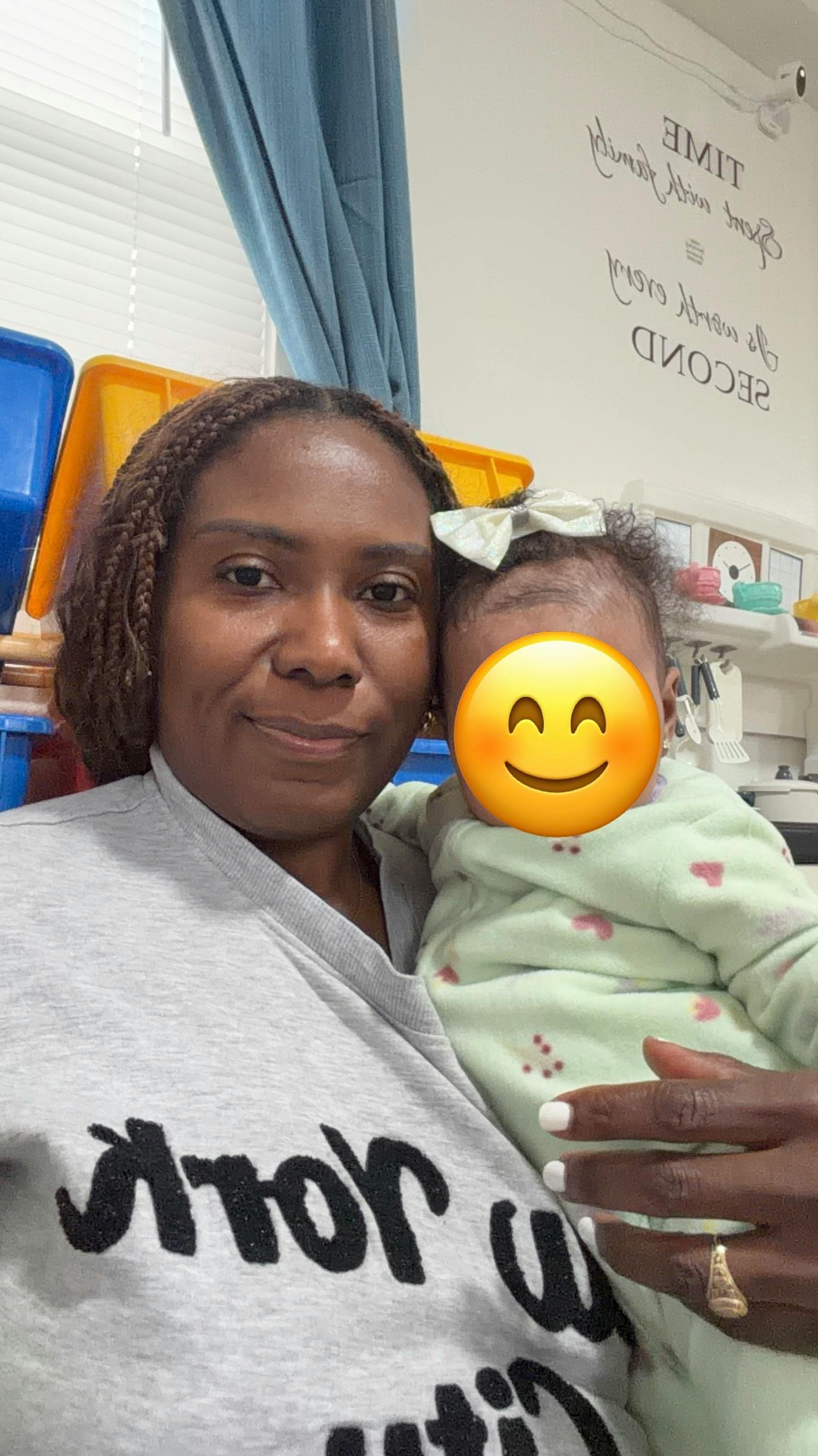 Adult holding a child in a room