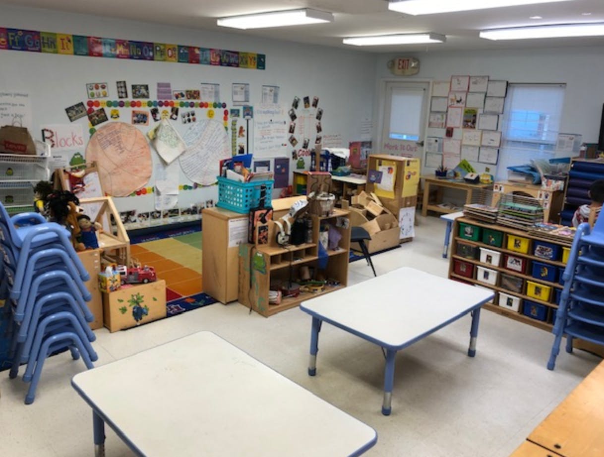 Empty classroom with small tables and chairs