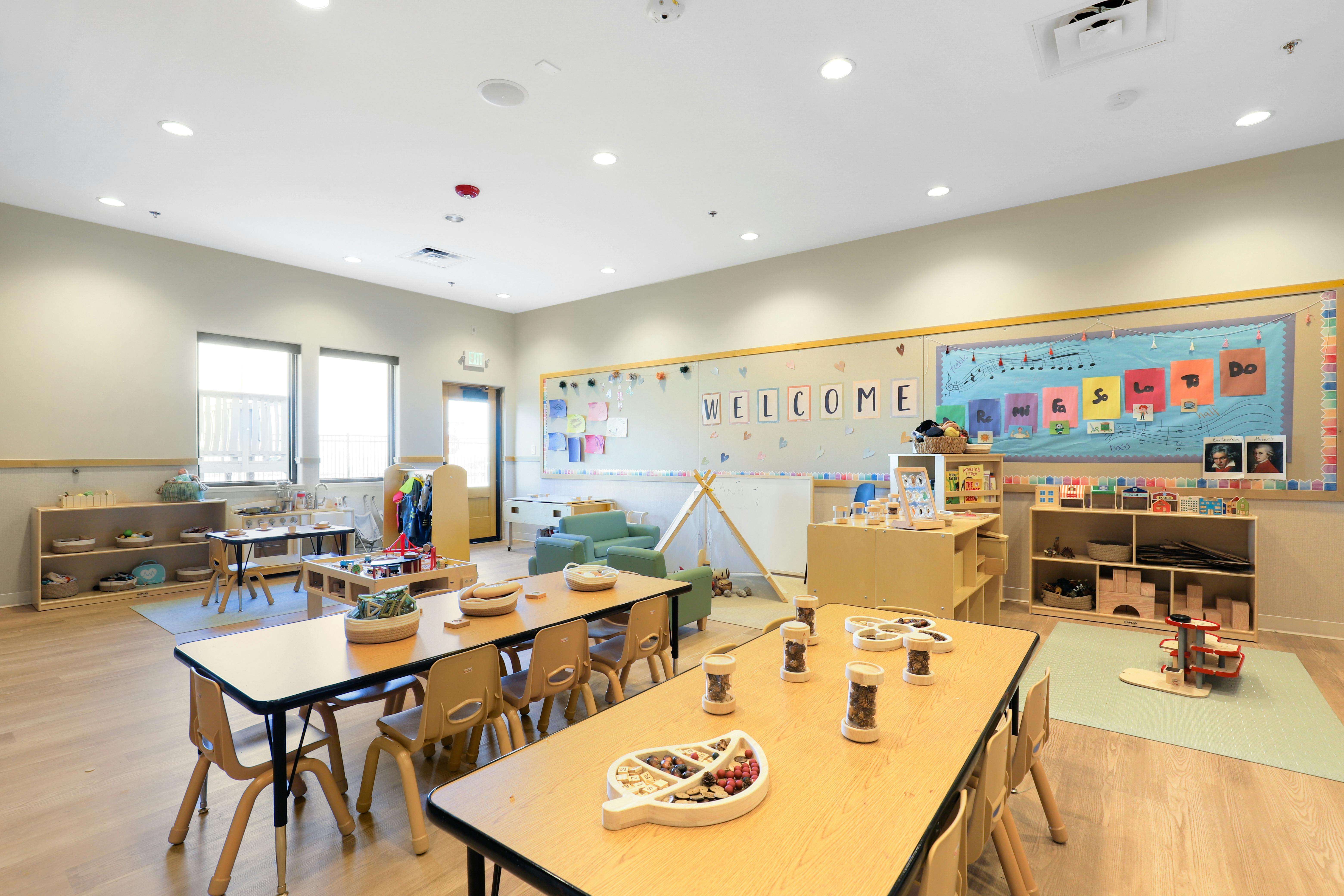 Empty classroom with small tables and chairs