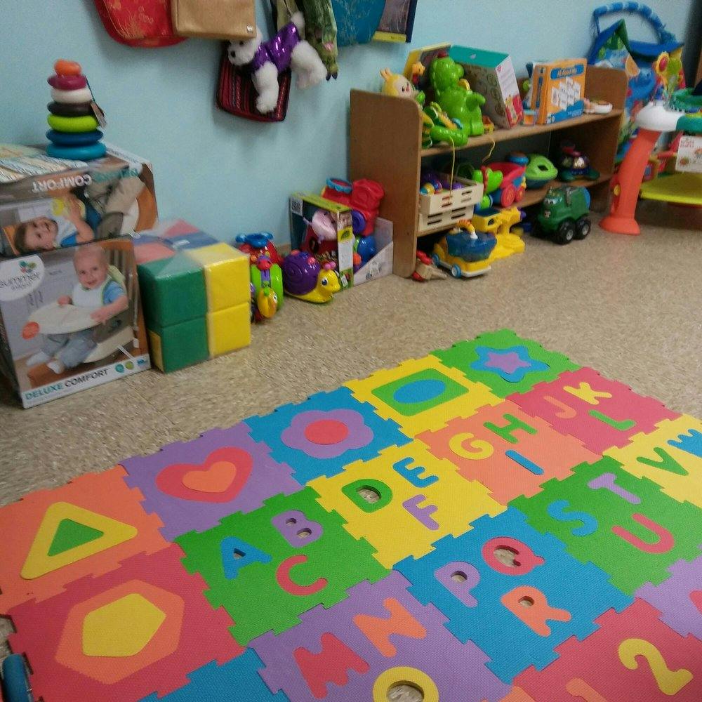 Playroom with alphabet floor mat and toys