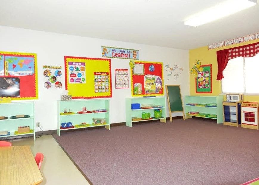 Empty classroom with colorful bulletin boards and shelves