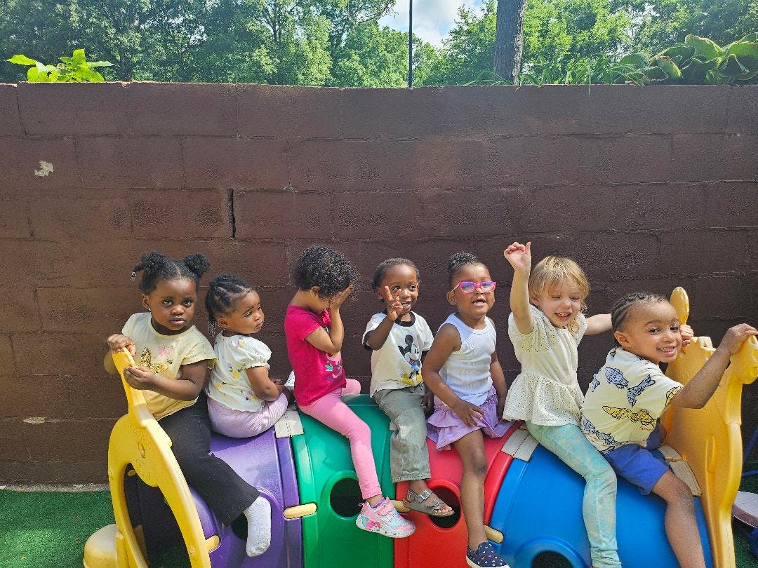 Group of children playing on a colorful playground toy