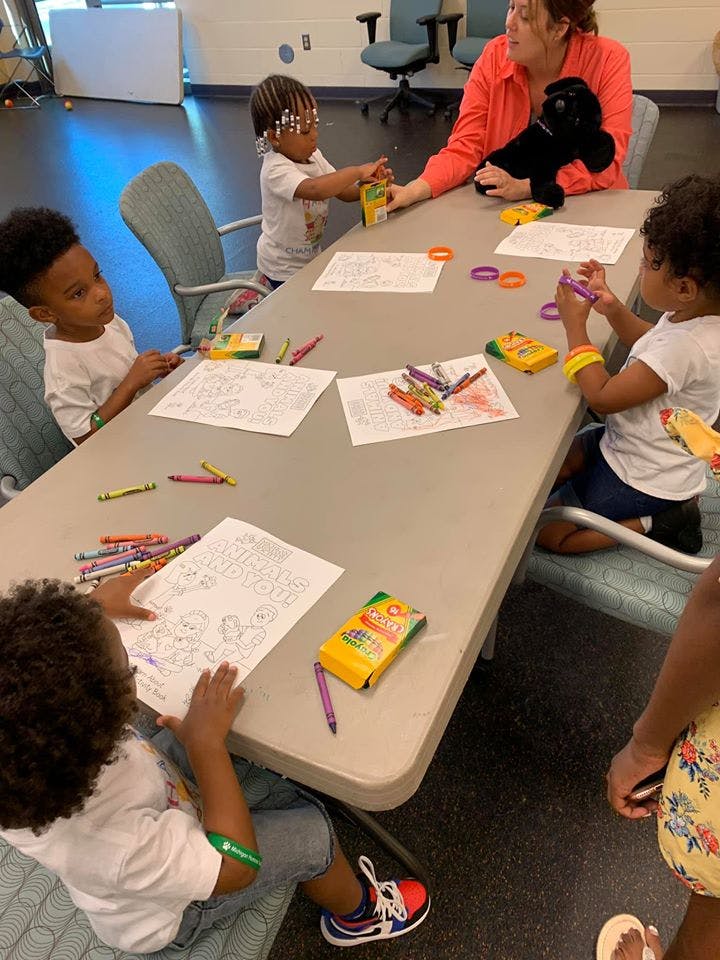 Adult and children coloring at a table