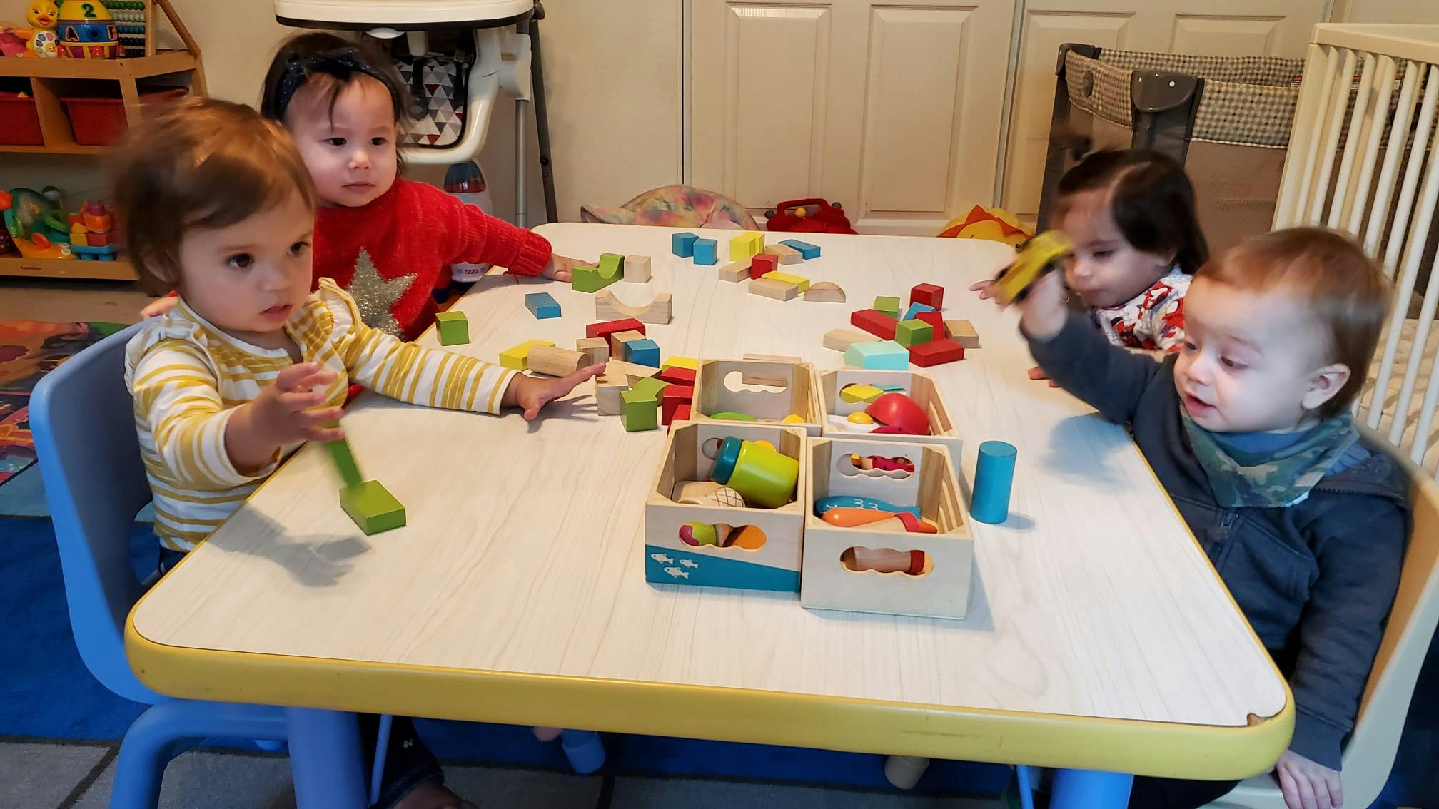 Children playing with toys at a table